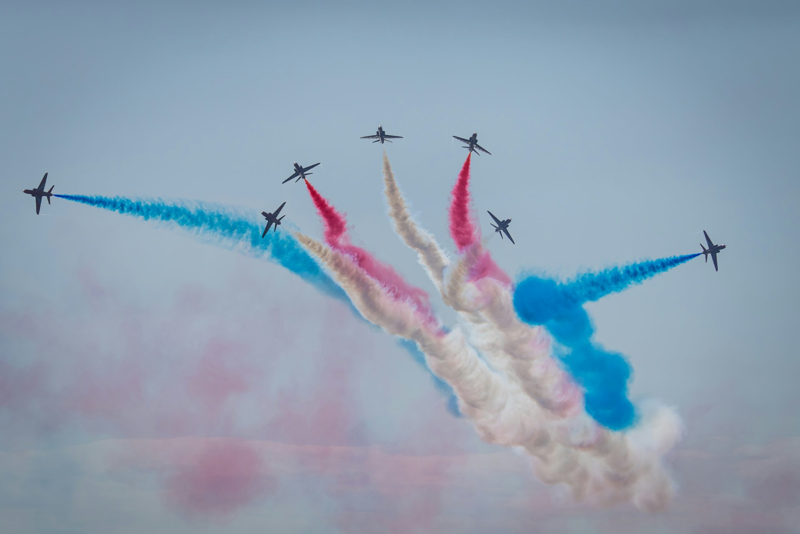 A group of airplanes flying in formation in the sky